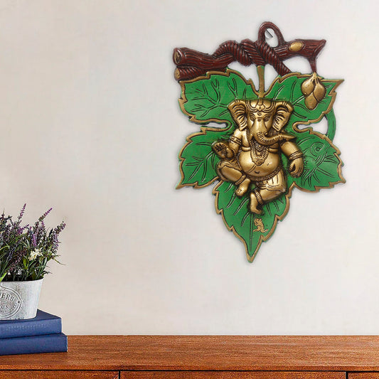 HomeSutra Dancing Golden Lord Ganesha on Green Leaf Metal Wall Hanging