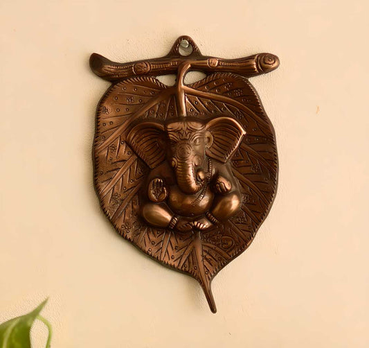 HomeSutra Metal wall hanging of Lord Ganesha on Leaf